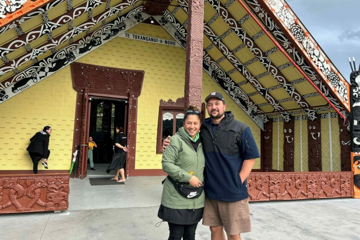 Erina Wehi-Barton and farmer Mohi Beckham in front of Te Tokanganui-a-Noho wharenui.