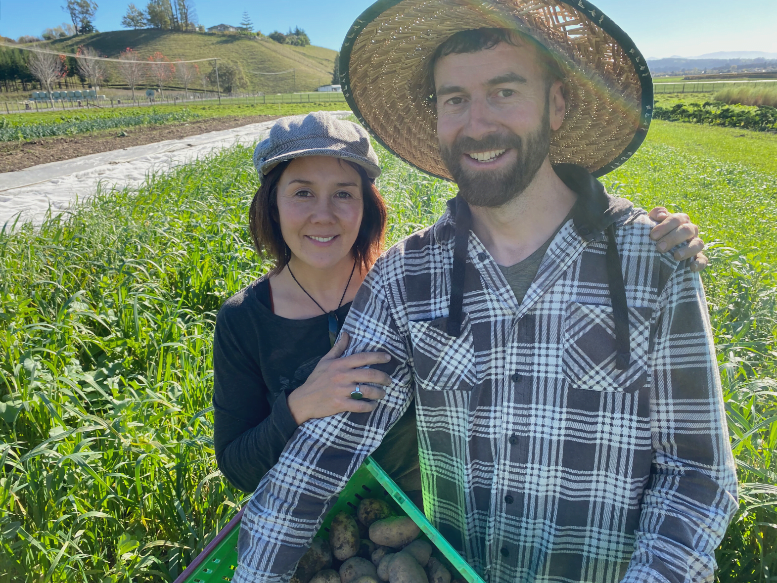 Market gardeners Dom Ferretti and wife Jeanette Ida in front of green crops they use to improve soil fertility for vegetable production